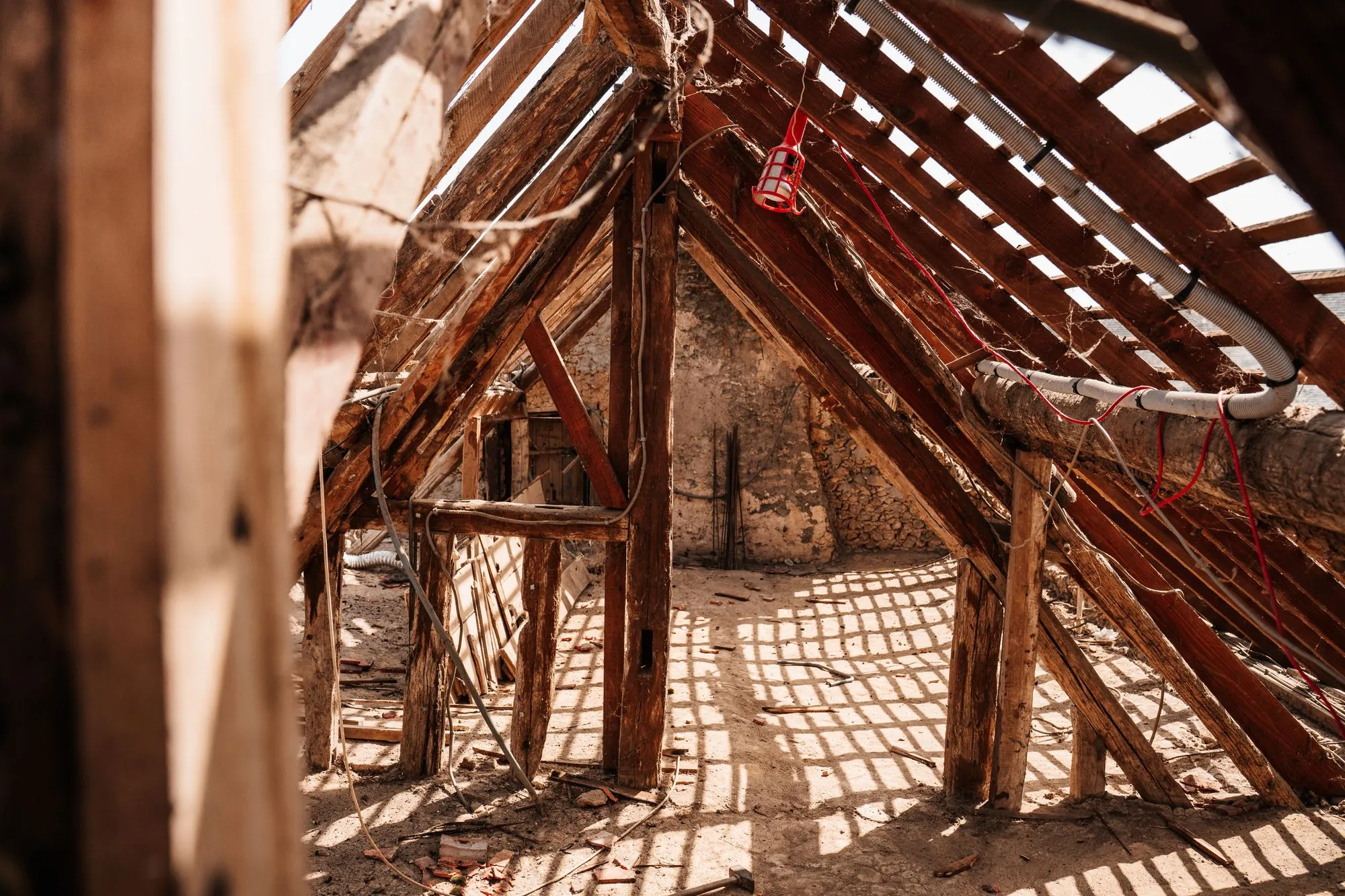 Exposed roof rafters and sheathing seen from inside an attic